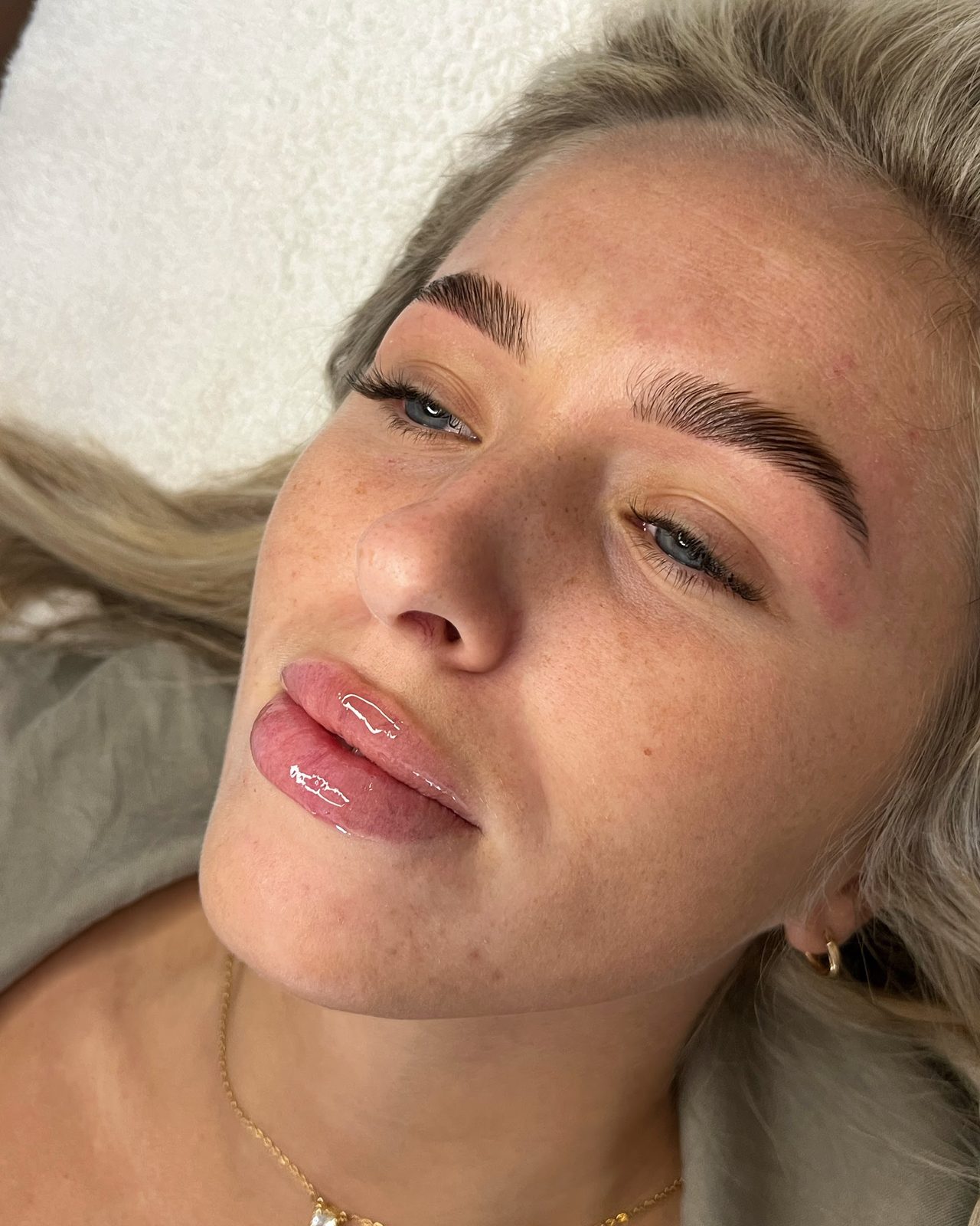 Shaped brows on a client with long blonde hair