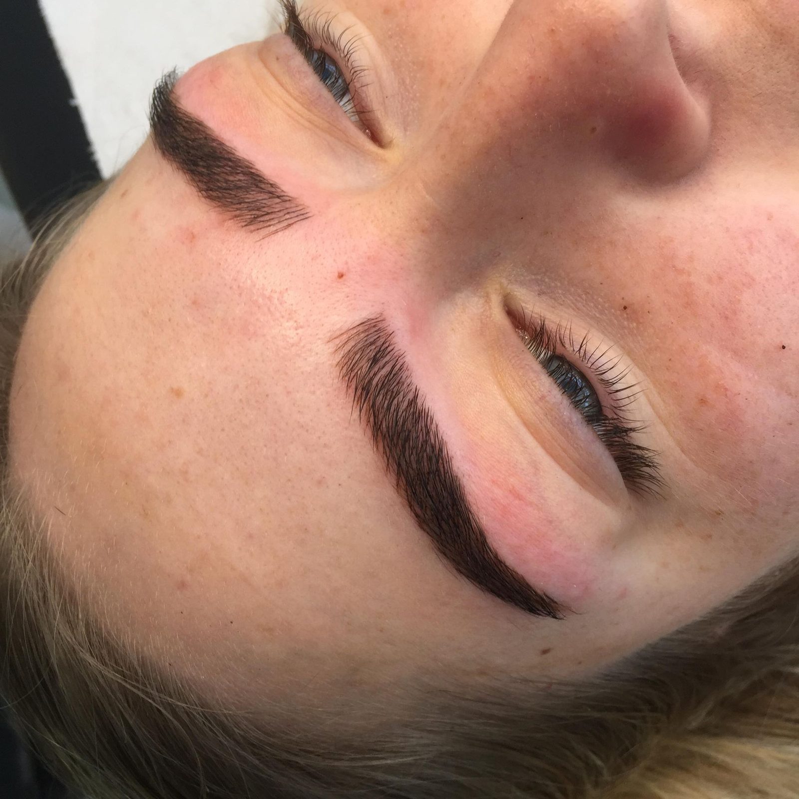 Close-up of dark, defined semi-permanent style brows