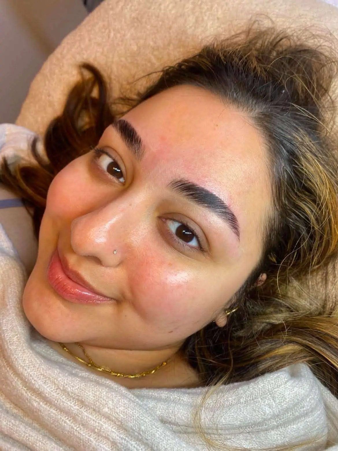 Rich, defined brows on a smiling client