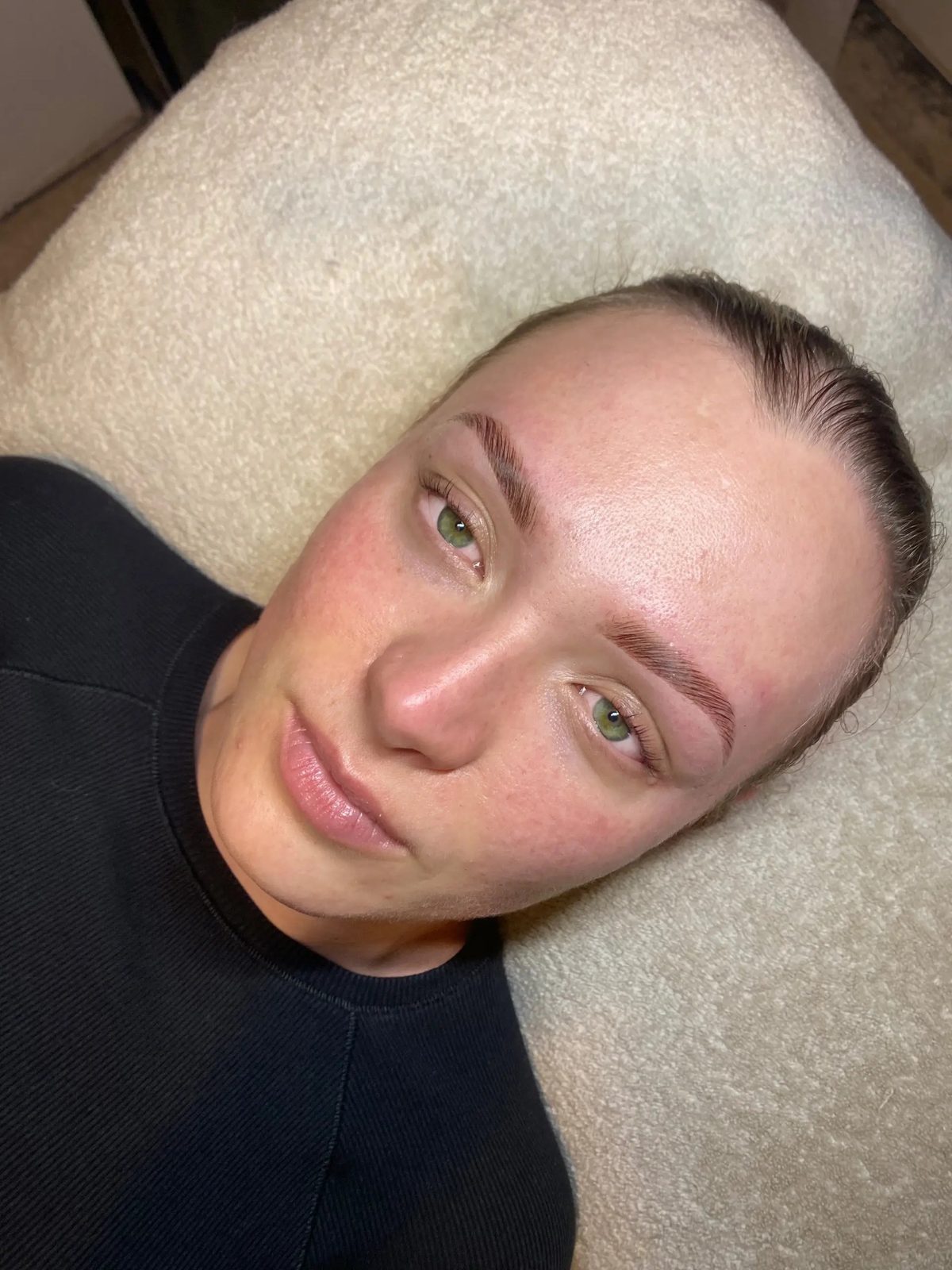 Soft shaped brows on a client in a black top